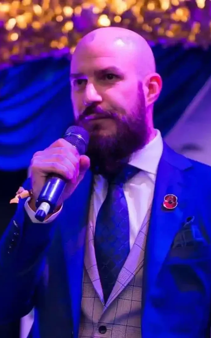 Headshot of Mark Hassell, a specialist business consultant at Velvet Compass Consulting, delivering a speech in a professional setting.